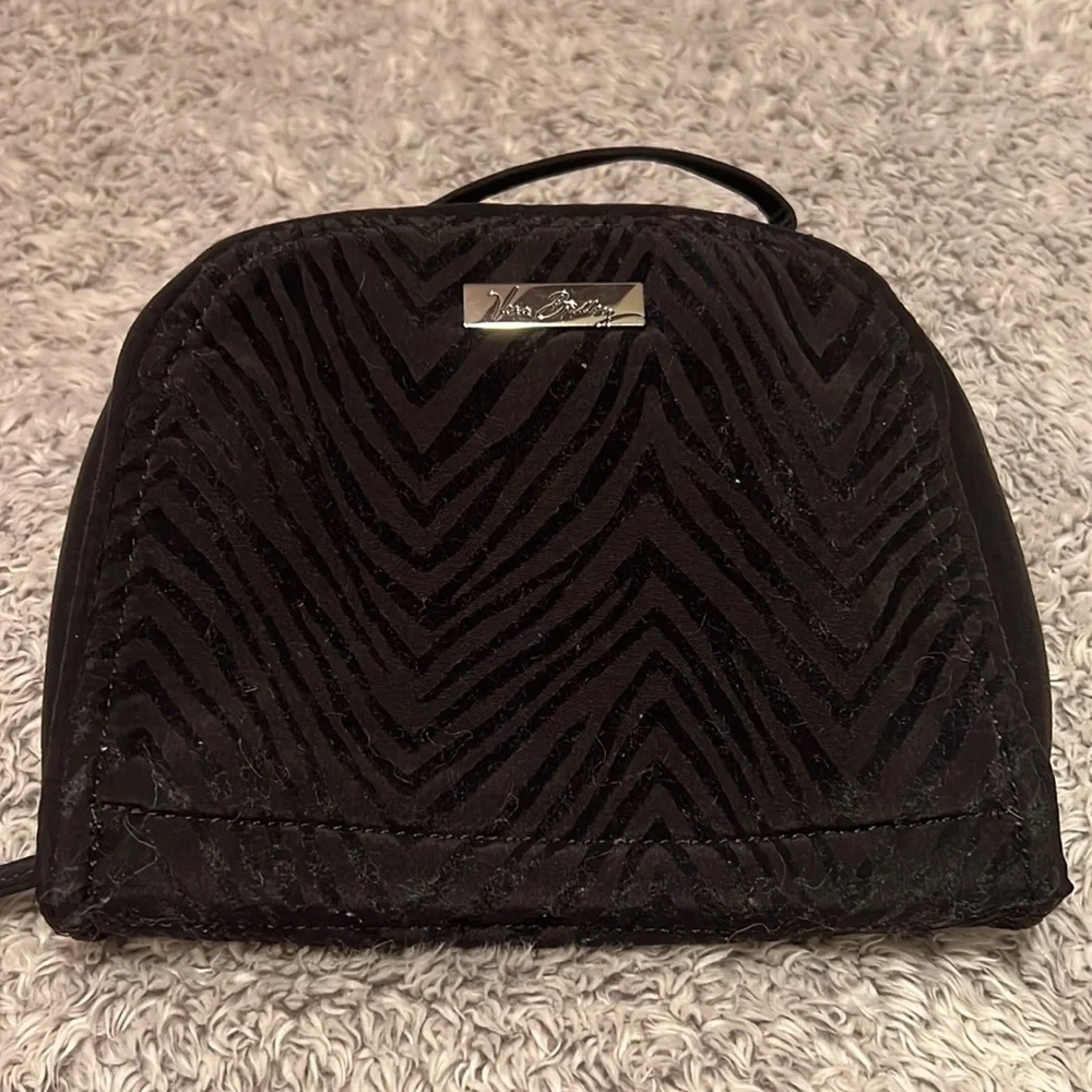 Vera Bradley black toiletry bag with 4 zippered pockets inside. Great condition!